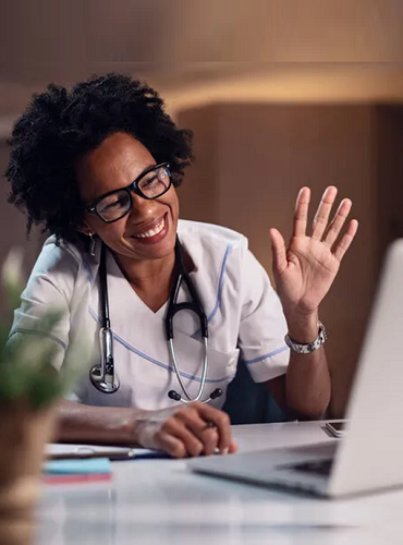 Black Doctor at Computer Waving